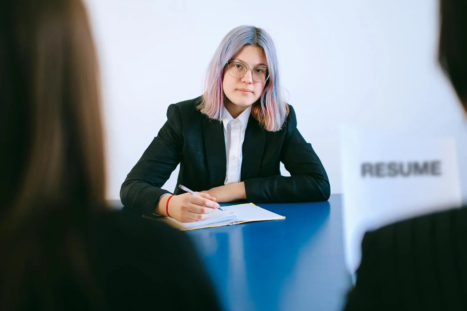 Candidate taking notes during a final interview while preparing clear answers and follow-up questions