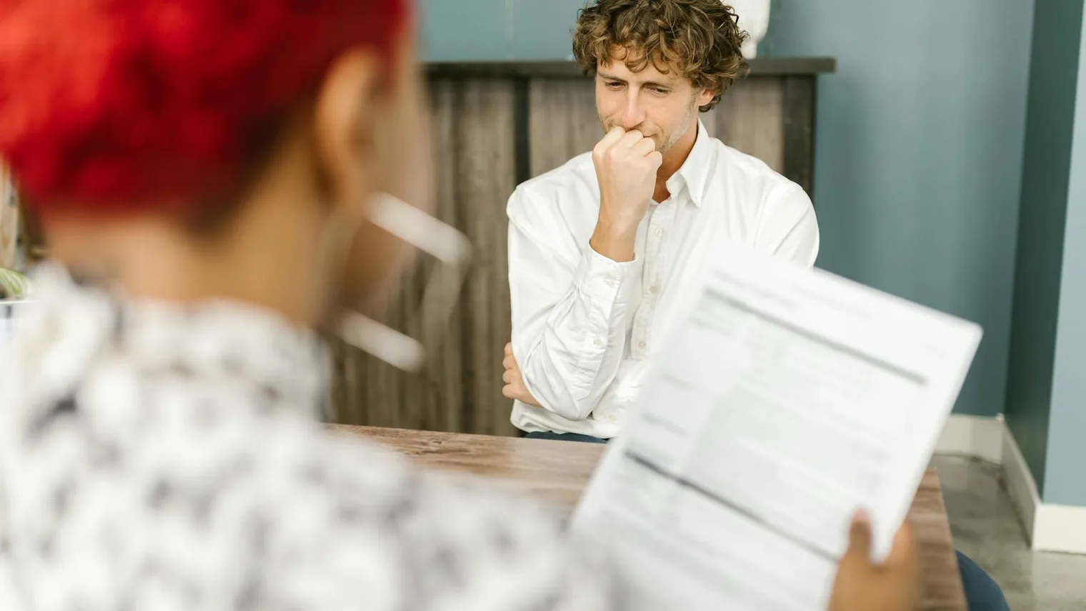 Candidate pausing to think during a job interview after receiving a question