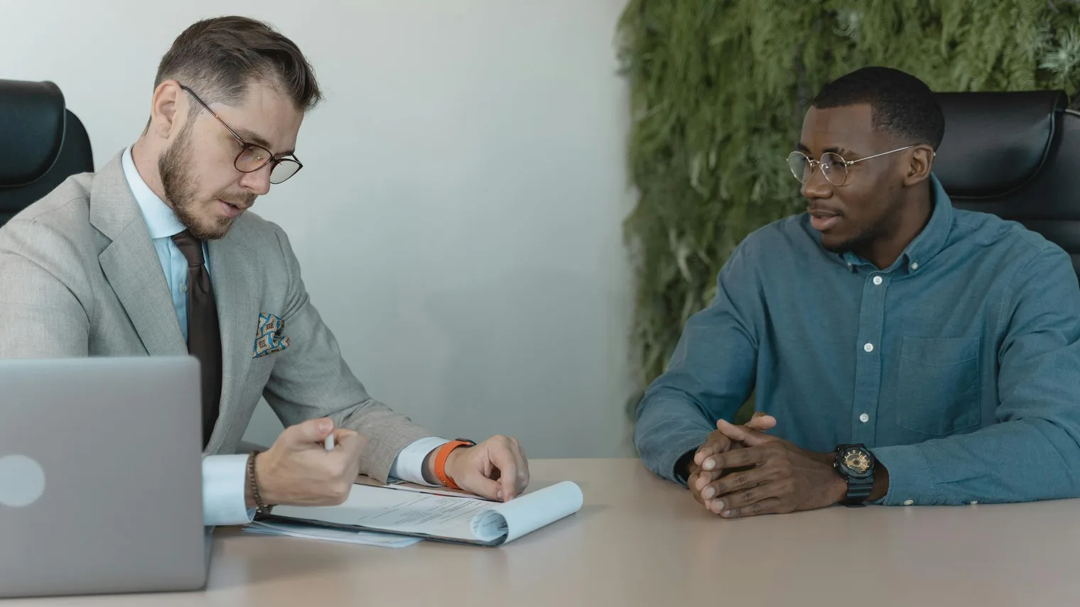 Interviewer reviewing a resume with a candidate during mock interview practice