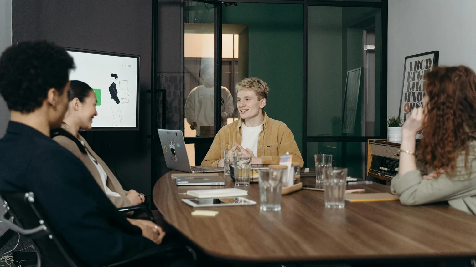 Group meeting around a conference table representing a panel interview conversation