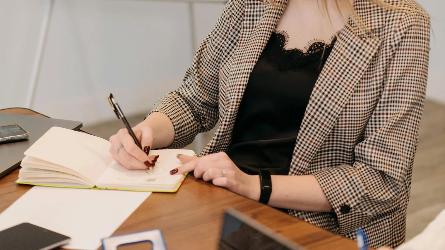 Candidate taking practice notes while pressure-testing resume strengths for interview follow-ups