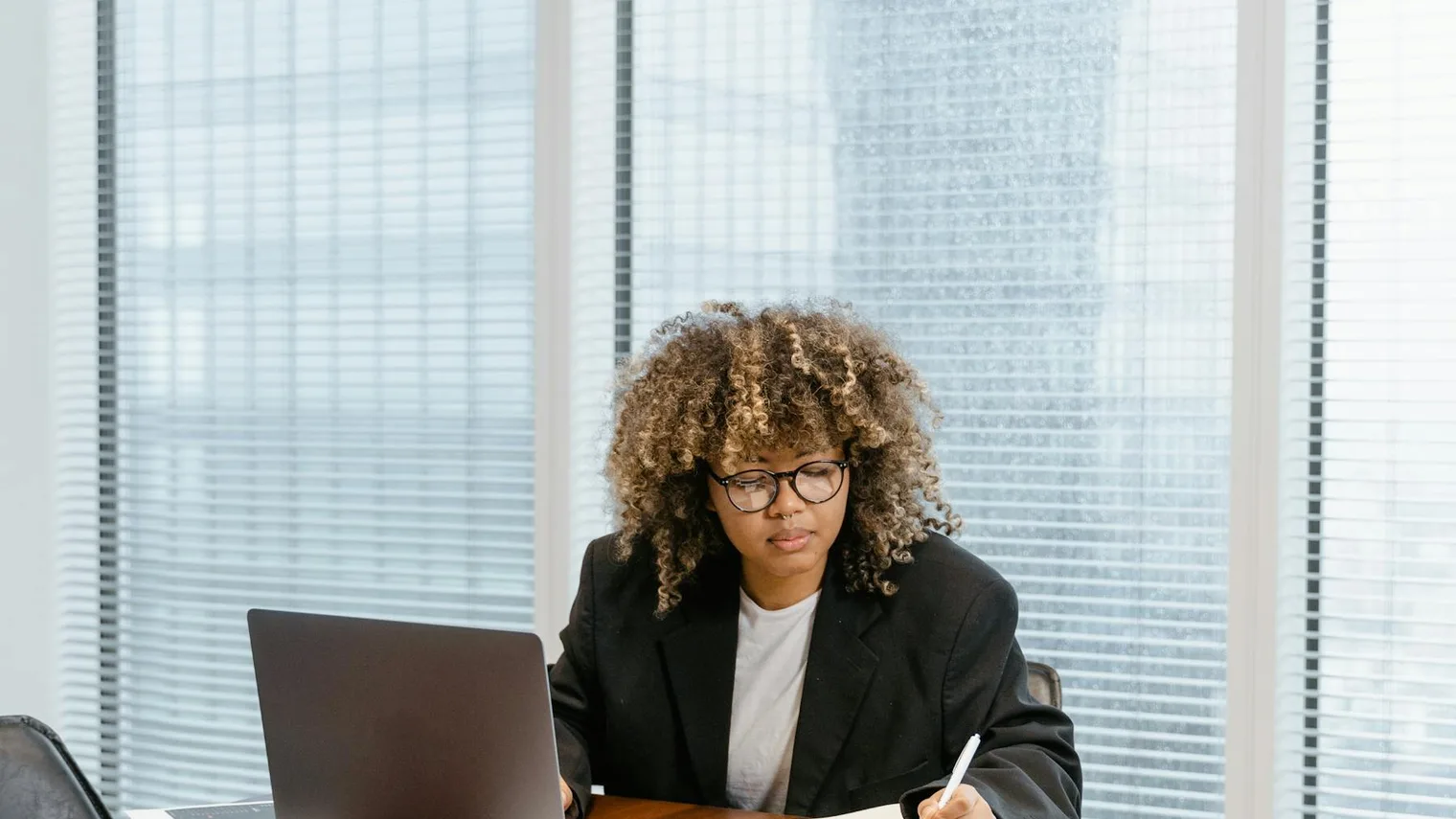 Candidate drafting a thank you email after an interview with notes and a laptop