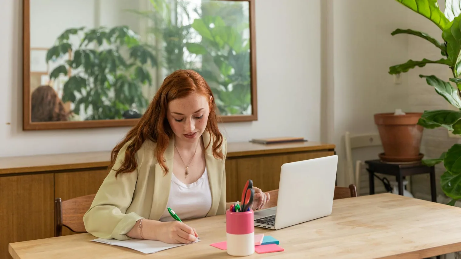 Workspace with a laptop and notebook for writing interview thank you email examples