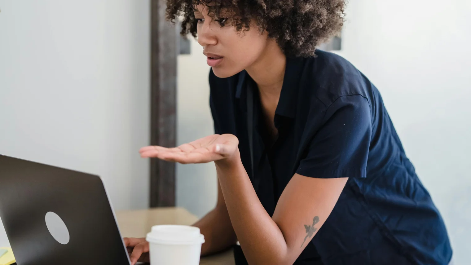 Candidate speaking on a laptop video call while practicing a video interview answer