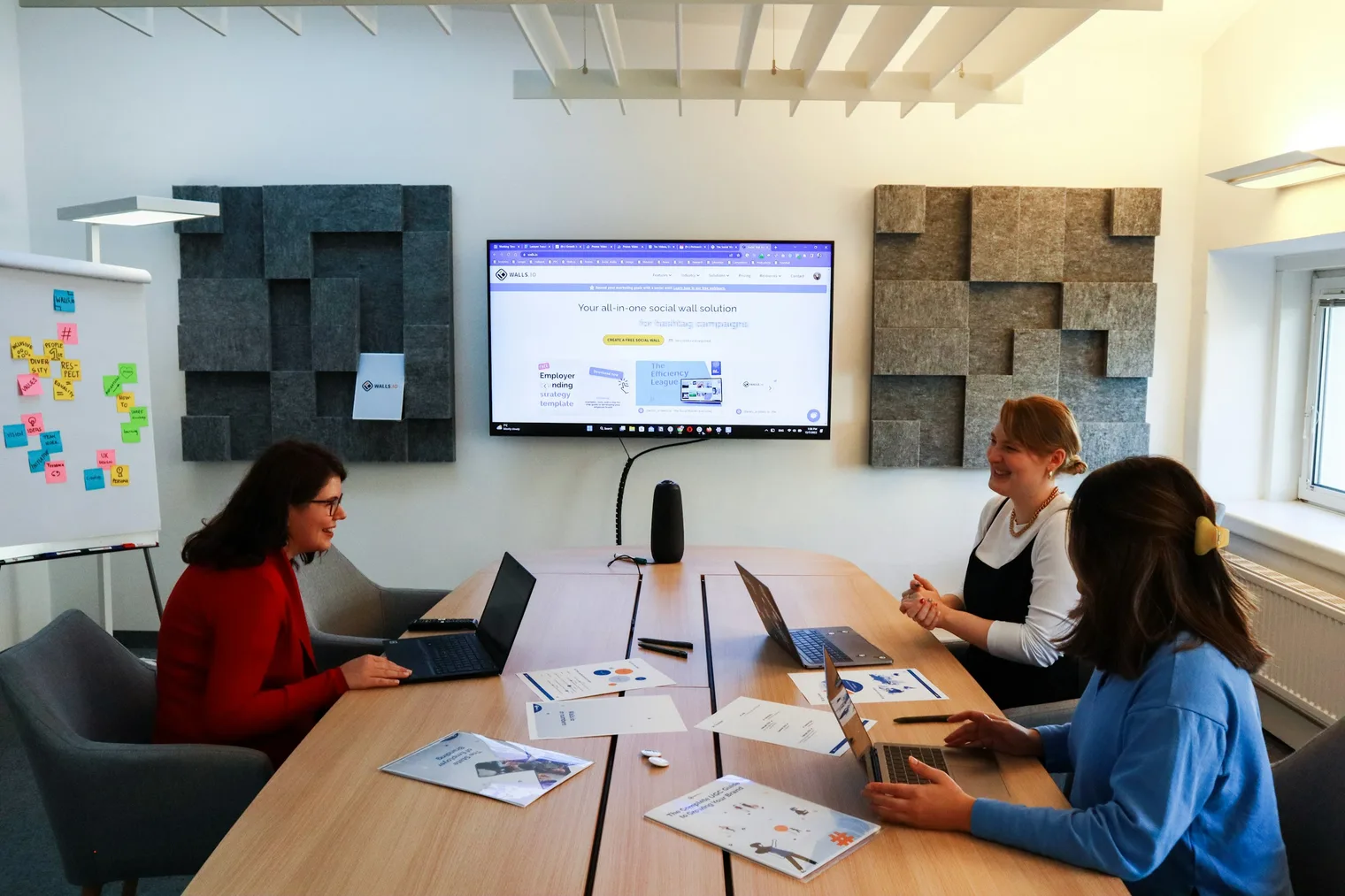 Team meeting in a conference room used to plan interview questions for managers and leadership stories