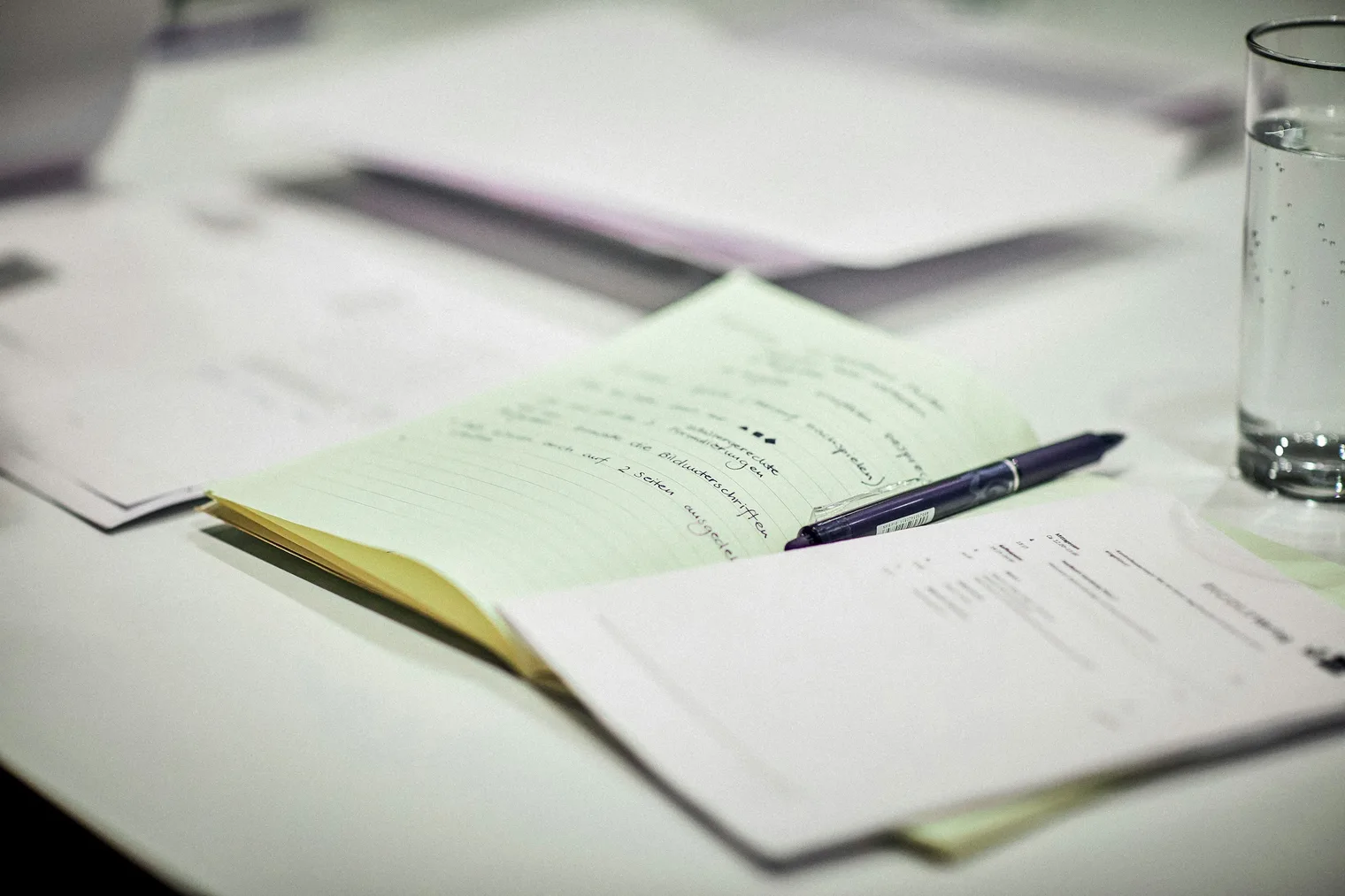 Interview notes and papers used to review answers to interview questions for managers after practice